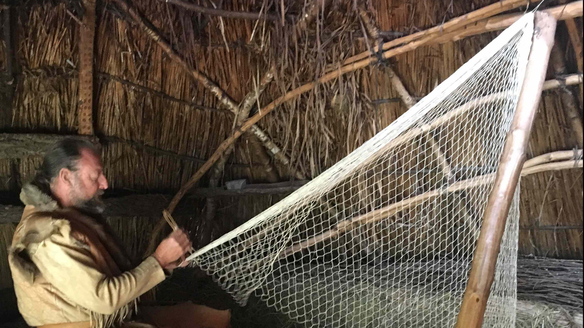 Weaving a fishernet in the Stone Age Park Dithmarschen (DE)